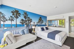 a bedroom with a bed and a couch with palm trees at Bay View Motel Number Four in Lorne