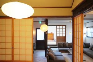 un soggiorno con pareti gialle e porte arancioni di 余韻 奈良宿 - yoinn narayado a Gojō
