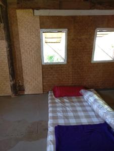 a room with two windows and a bed in it at Farmer house on Beverley hill Pai in Pai