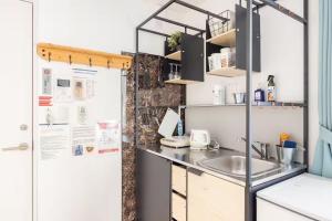 a kitchen with a sink and a refrigerator at Pet Friendly 7min to Haneda Quick Access to Shinagawa and Tokyo in Tokyo +21 photos