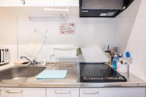 a kitchen with a sink and a counter top at Dream蒲田 in Tokyo