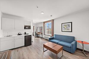 a living room with a blue couch and a kitchen at Hampton Inn by Hilton Calexico in Calexico