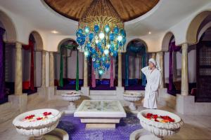 a statue of a nun in a room with two tables at Spice Hotel & Spa - Ultra All Inclusive in Belek +37 photos