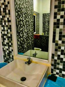 a bathroom with a sink and a mirror at Brightness Villa,Private Home Stay in Phumĭ Poŭthĭ Mâ Srei