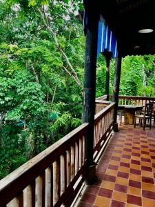 a porch of a resort with a view of a forest at Brightness Villa,Private Home Stay in Phumĭ Poŭthĭ Mâ Srei