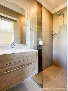 a bathroom with a sink and a shower at 7Pillars Shiraz in Durbanville