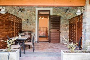 a patio with a table and chairs and a brick wall at Anna dei Sapori in Castelnuovo Cilento +31 photos