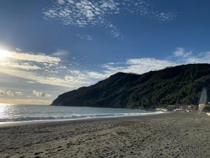 a view of a beach with a mountain in the background at Your Sea Escape in Riva Trigoso