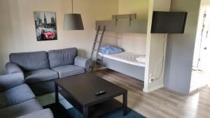 a living room with a couch and a bunk bed at Rättviks Golfby in Rättvik