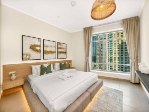 a bedroom with a large bed and a large window at Royal Vista at Burj Views - Dubai City & Burj Khalifa Views - Brand New Luxury 2BR Apartment in Dubai +66 photos