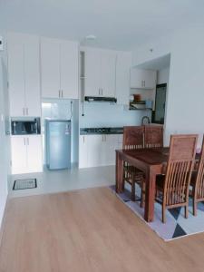 a kitchen with a table and chairs and a refrigerator at Irdina Homestay in Banting