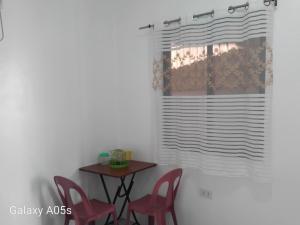 a room with a table and chairs and a window at Francis Home Stay Port Barton bonifacio street in San Vicente +13 photos