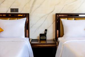 Postel nebo postele na pokoji v ubytování Phuc Hai Hotel Da Lat