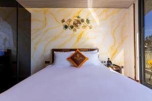 Postel nebo postele na pokoji v ubytování Phuc Hai Hotel Da Lat