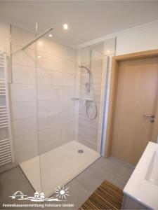 a shower with a glass door in a bathroom at 53 Ferienwohnung im Fritz-Bleyl-Weg 14 OG rechts in Burg auf Fehmarn