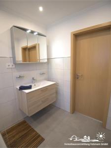 a bathroom with a sink and a mirror at 51 Ferienwohnung im Fritz-Bleyl-Weg 14 EG rechts in Burg auf Fehmarn