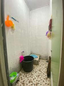 a small bathroom with a tub and a toilet at Embun Padi Homestay in Karawang +1 photo