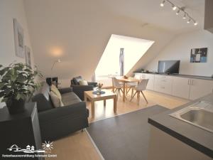 a living room with a couch and a table at 56 Ferienwohnung im Fritz-Bleyl-Weg 14 DG links in Burg auf Fehmarn