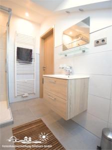 a bathroom with a sink and a mirror at 56 Ferienwohnung im Fritz-Bleyl-Weg 14 DG links in Burg auf Fehmarn