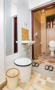 a bathroom with a tub and a sink and a toilet at Jay Homes - Naiva Heights in Naivasha