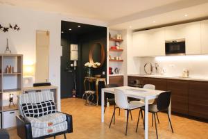 a kitchen and living room with a table and chairs at Charming T2 with balcony near the Bastille in Paris