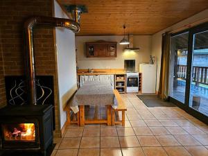 a kitchen with a fireplace and a stove in a room at Le Nénuphar - Chalet avec terrasse in Mélisey