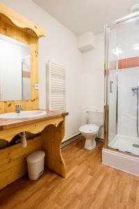 a bathroom with a sink and a toilet and a shower at CozySerenity, Orelle & Les 3 Vallées in Orelle