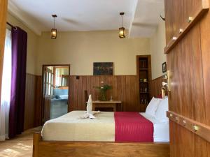 a bedroom with a bed with a bird on it at Lily Bank Cottage in Nuwara Eliya +20 photos