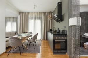 a kitchen and living room with a table and chairs at Anvy Stylish Suites Ioannina in Ioannina
