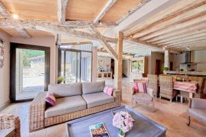 a living room with a couch and a table at Maison 5 étoiles luxe 6p piscine privée chauffée Lascaux in Saint-Amand-de-Coly