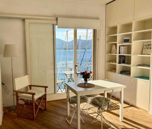 a kitchen with a table and a view of the ocean at Monolocale La Darsena in Portoferraio +33 photos