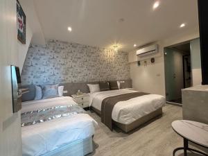 Uma cama ou camas num quarto em 墾丁卿卿文旅