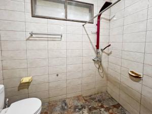 a bathroom with a toilet and a red hose at Large Villa Ciater 3BR near Sariater by 2ndHome in Sarireja +20 photos