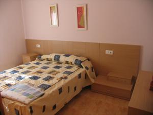 a small bedroom with a bed and a table at Encarni in Riumar +30 photos