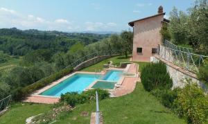 The swimming pool at or close to Villa il Pino by VacaVilla