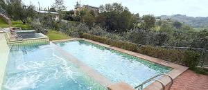 The swimming pool at or close to Villa il Pino by VacaVilla