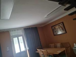 a dining room with a table and chairs and a window at Gránás paradise in Gánt