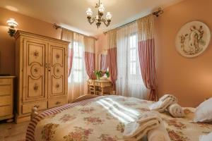 a bedroom with a bed and a dresser at Hotel Monte Cristo in Kotor