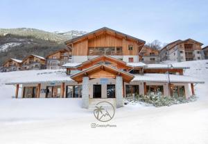 a building with snow on the ground in front of it at CozyLoge, Orelle & Les 3 vallées in Orelle