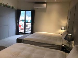 Rúm í herbergi á 宜蘭白鵝田園 l 包棟Villa