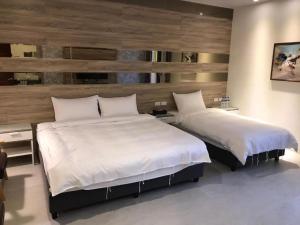 Rúm í herbergi á 宜蘭白鵝田園 l 包棟Villa