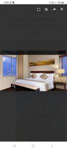 a poster of a bedroom with a bed and a window at Ex Hotel Aston Marina Ancol in Jakarta