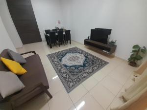 a living room with a couch and a rug at Homestay As Sofiyya 2 in Sungai Petani
