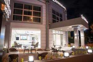 a restaurant with tables and chairs in front of a building at Altınova Hotel Sakarya in Serdivan