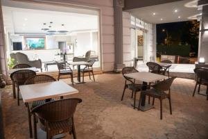 a restaurant with tables and chairs and a patio at Altınova Hotel Sakarya in Serdivan