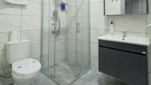 a bathroom with a shower and a toilet and a sink at Altınova Hotel Sakarya in Serdivan +37 photos