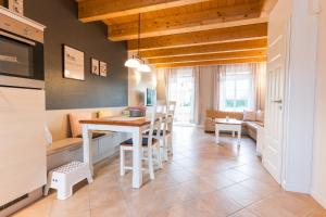 a kitchen and living room with a table and chairs at Alte Schule 7 in Staberdorf