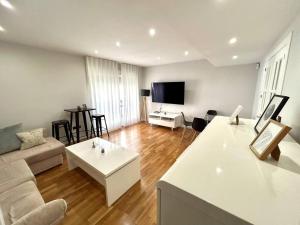 a living room with a couch and a table at La Catedral - Más que apartamentos lujo in Murcia