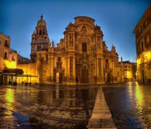 an old building in a city at night at La Catedral - Más que apartamentos lujo in Murcia