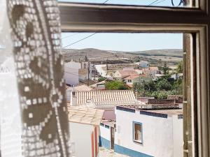 a view of a city from a window at Casa Roma in Raposeira